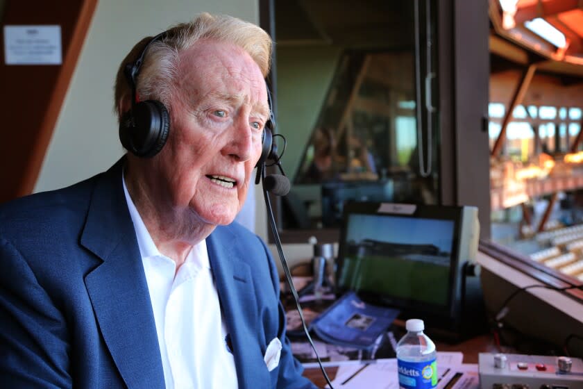 Legendary Los Angeles Dodgers broadcaster Vin Scully sits in the booth at Camelback Ranch Glendale, Ariz.